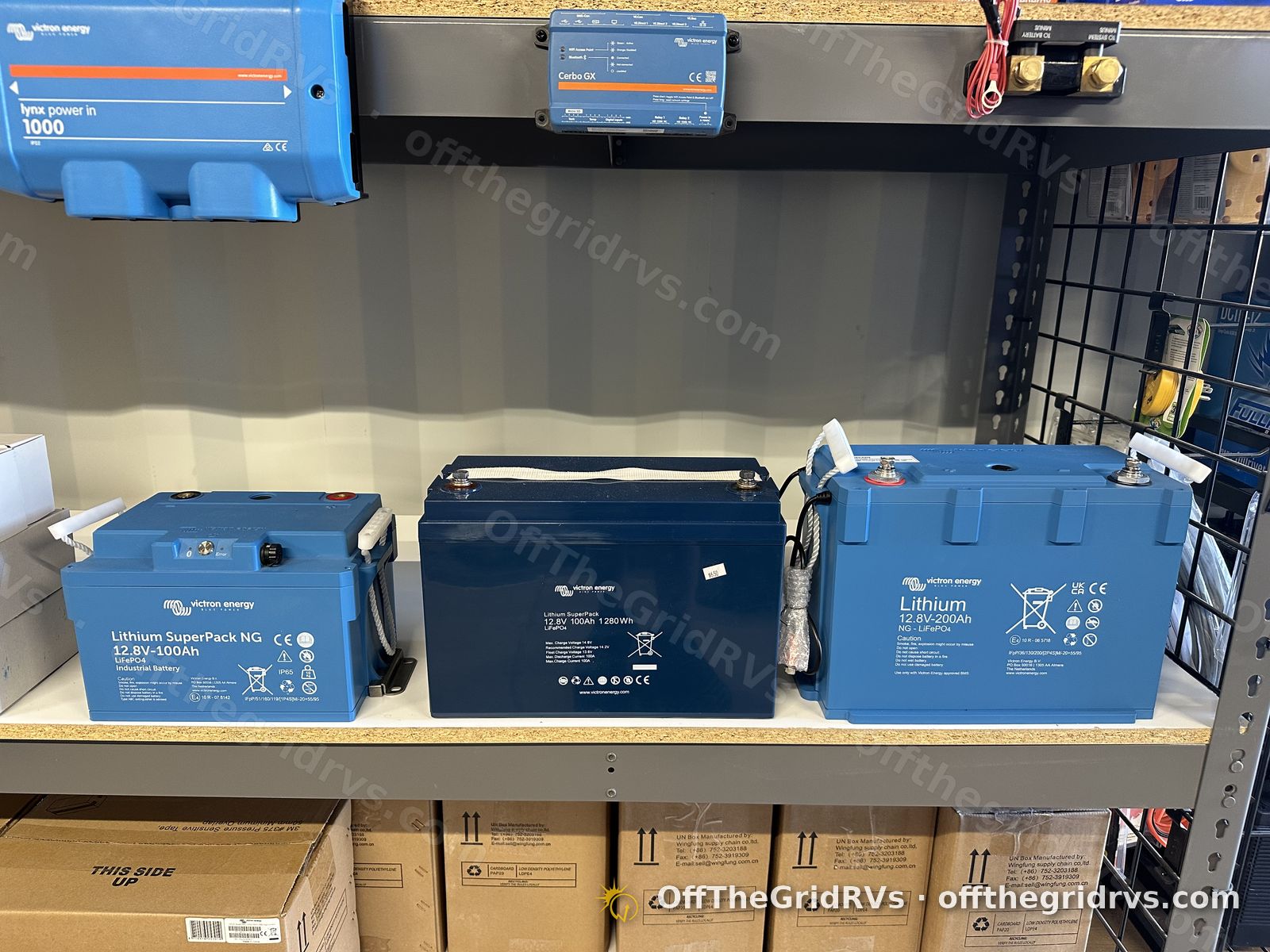 Victron Energy lithium batteries, including 12.8V 100Ah and 12.8V 200Ah NG models, on the showroom shelf